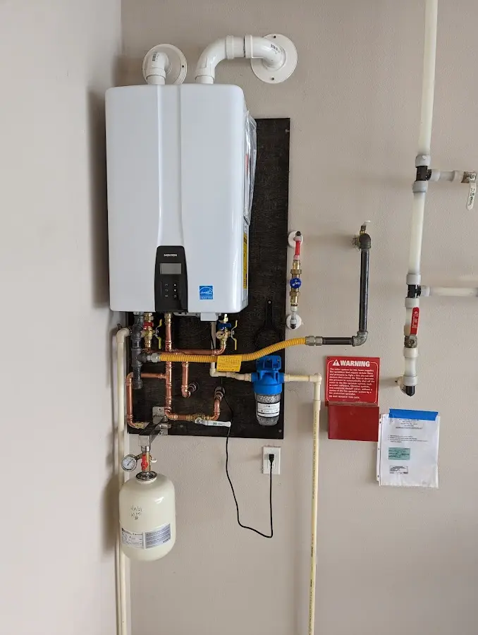 Professional plumber installing copper piping in a Iroquois Point home